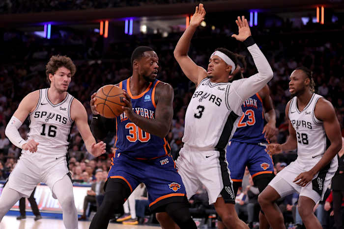 New York Knicks forward Julius Randle (30) controls the ball against San Antonio Spurs forwards Cedi Osman (16) and Keldon Johnson (3) and center Charles Bassey (28) during the third quarter at Madison Square Garden.